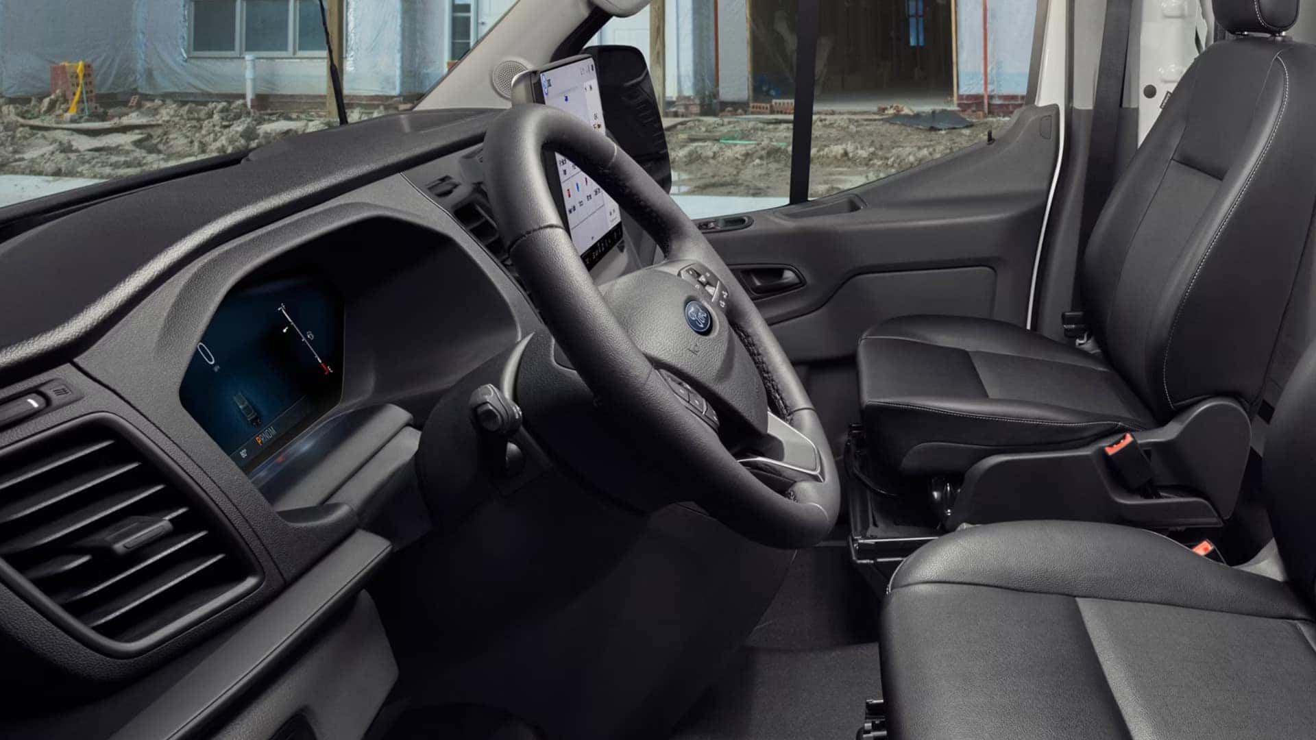 2026 Ford Transit® front cabin with driver seat, steering wheel, touchscreen display, and work-ready layout.