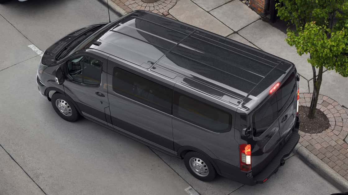 2026 Ford Transit® gray passenger van seen from above with tinted windows, roof panels, and urban van styling.