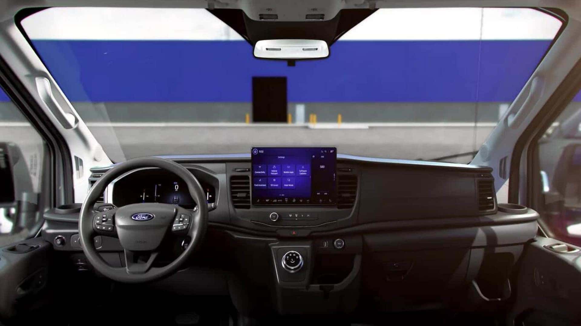 2026 Ford E-Transit™ interior dashboard with digital display, large touchscreen, rotary shifter, and wide cabin view.