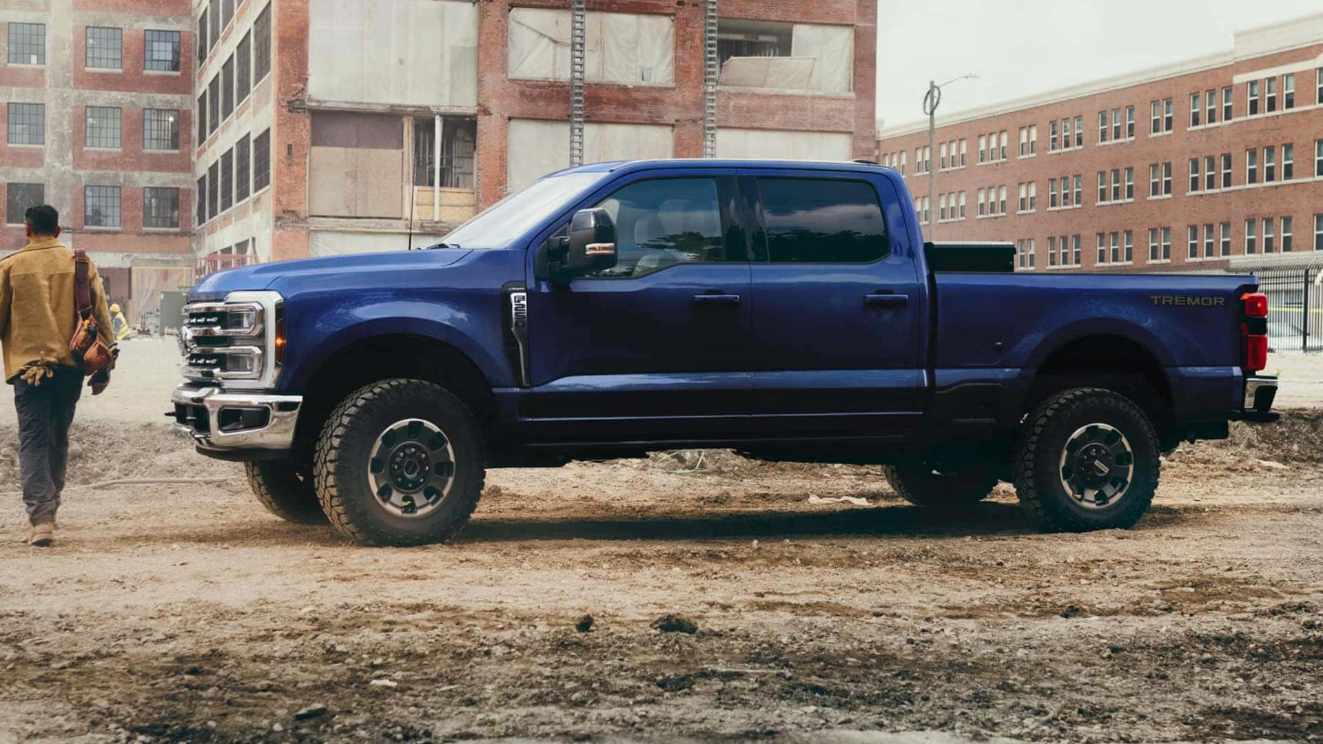 2026 Ford Super Duty® Tremor in blue parked at a construction site with off-road tires and crew cab design.