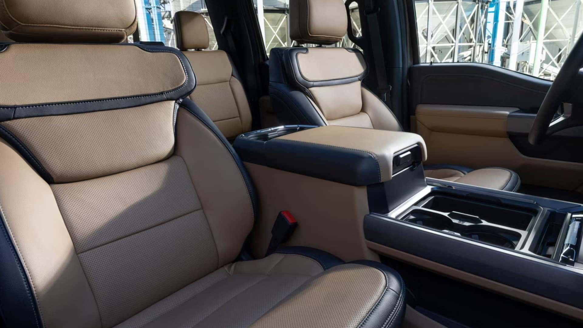 2026 Ford Super Duty® front cabin with tan leather seating, large center console, and premium truck interior.