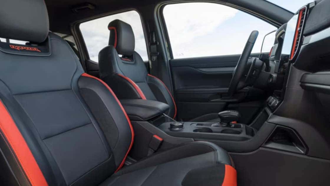 2025 Ford Ranger® interior with black and orange trimmed seats, center console, and rugged cabin styling.