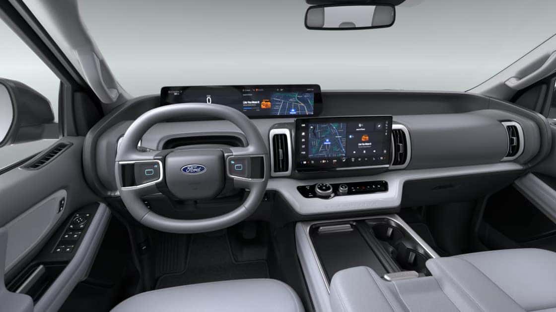 2026 Ford Expedition® interior with wide digital displays, gray seating, and spacious front cabin layout.
