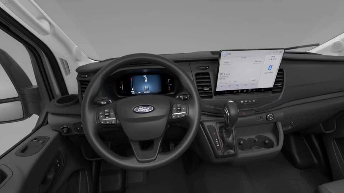 2026 Ford Transit® interior with steering wheel, digital display, large touchscreen, and practical van controls.