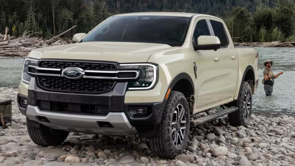 2025 Ford Ranger® pickup parked on a rocky riverbank with off-road tires and outdoor adventure styling.
