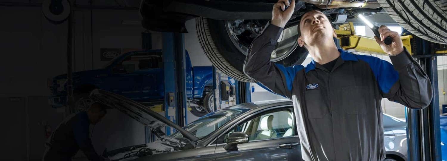 Ford technician looking under vehicle