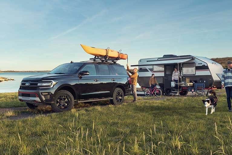 Expedition with camper near a lake