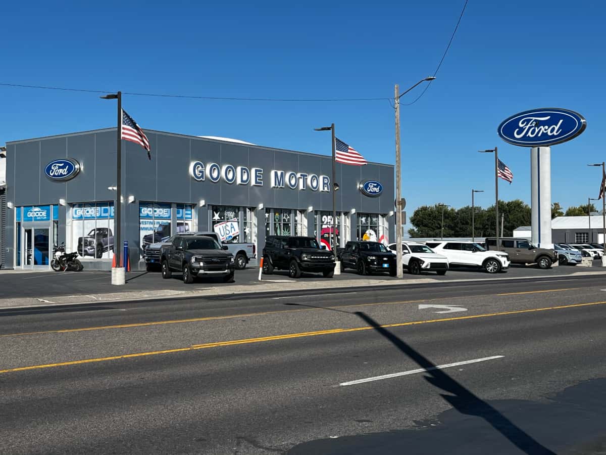 Goode Motor Ford dealership storefront on Main Street in Burley, Idaho, with new Ford trucks and SUVs on the lot