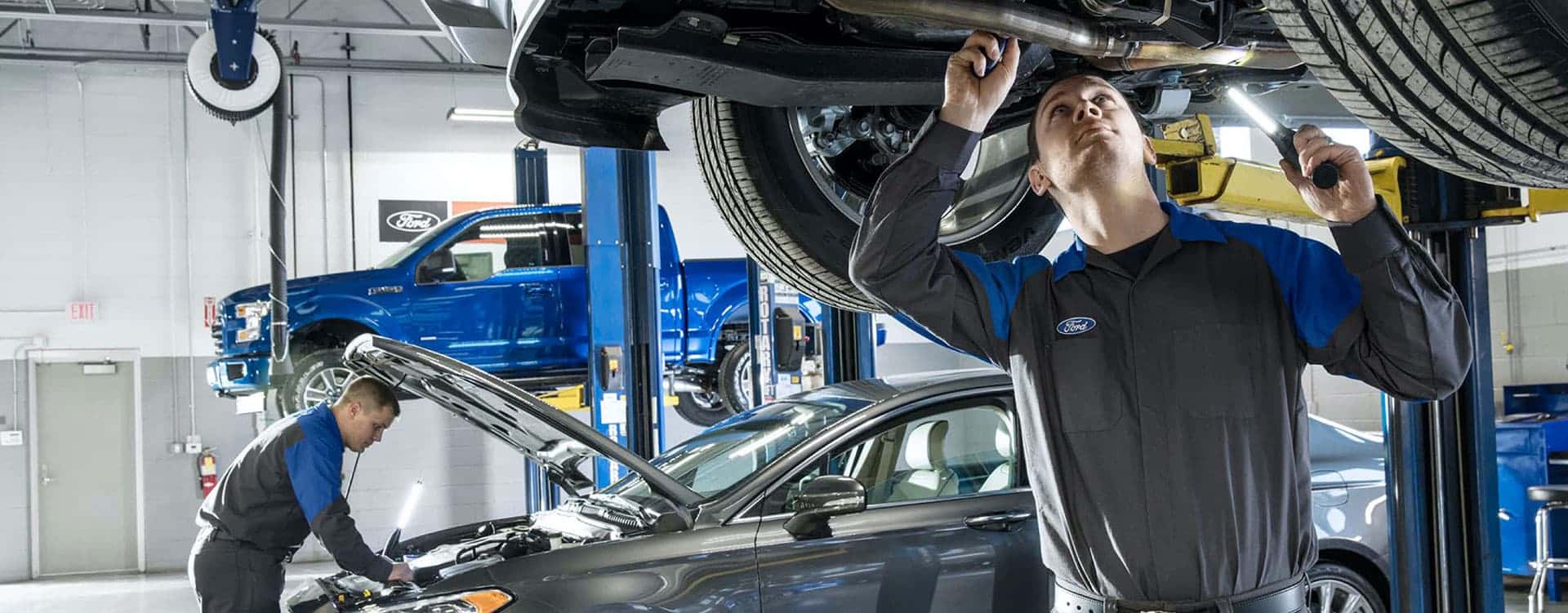 Mechanics working on Ford vehicles
