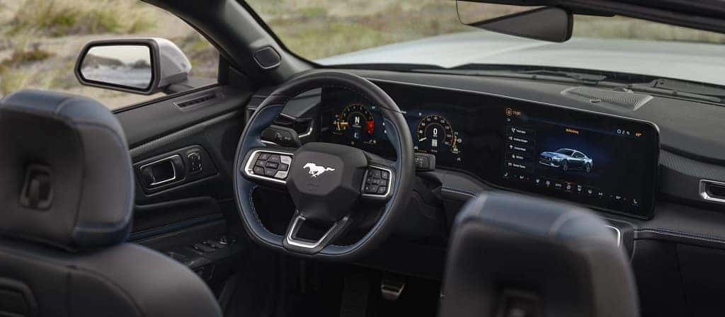 The dashboard and steering wheel of the 2025 Ford Mustang.