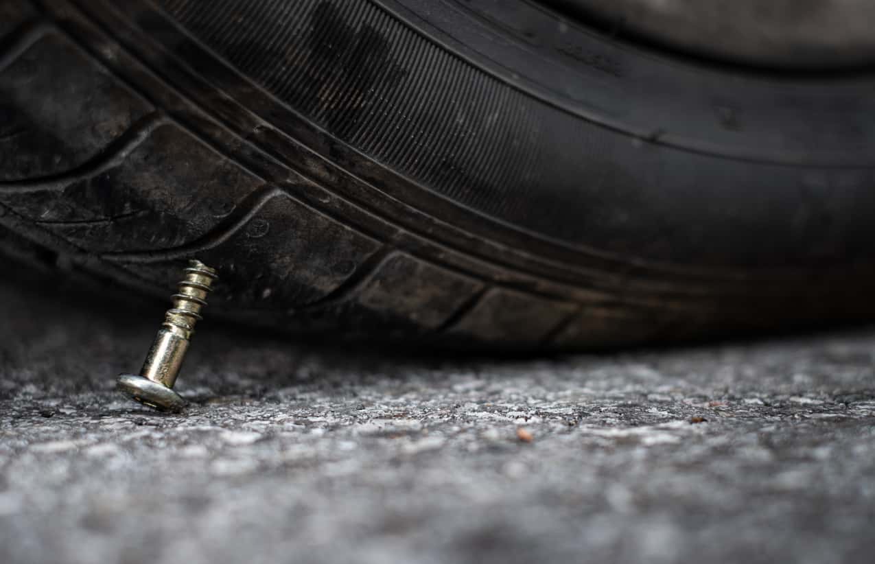 A screw sticking out of a tire that drove over it.