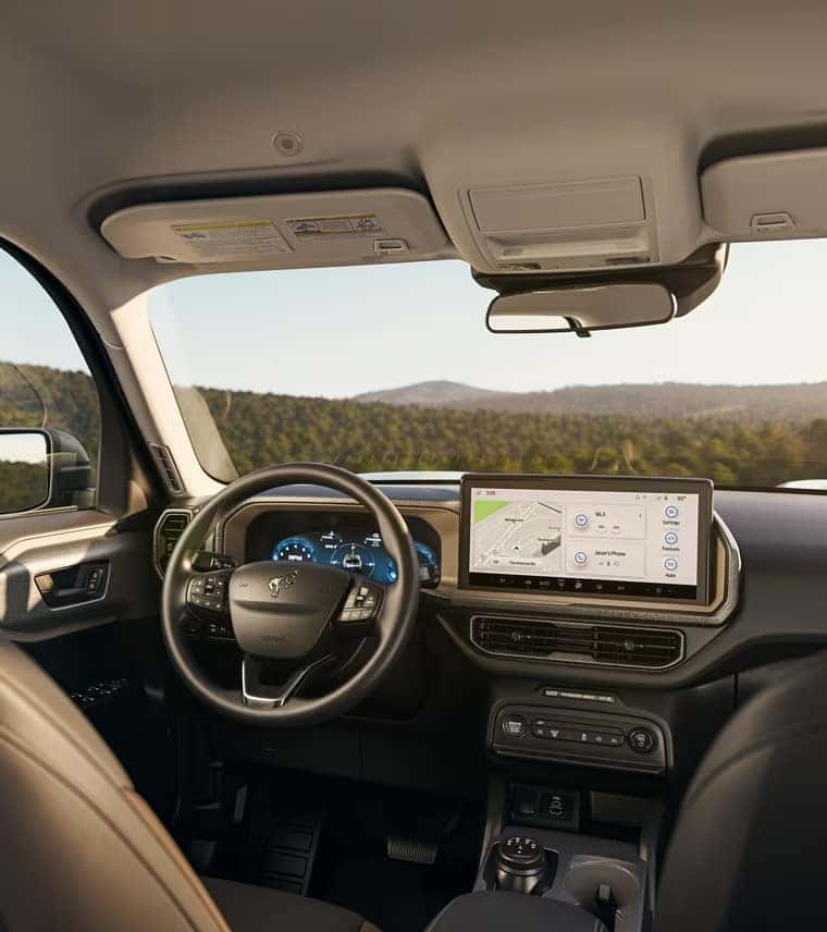 The interior of the 2025 Bronco Sport showing the dashboard and steering wheel.
