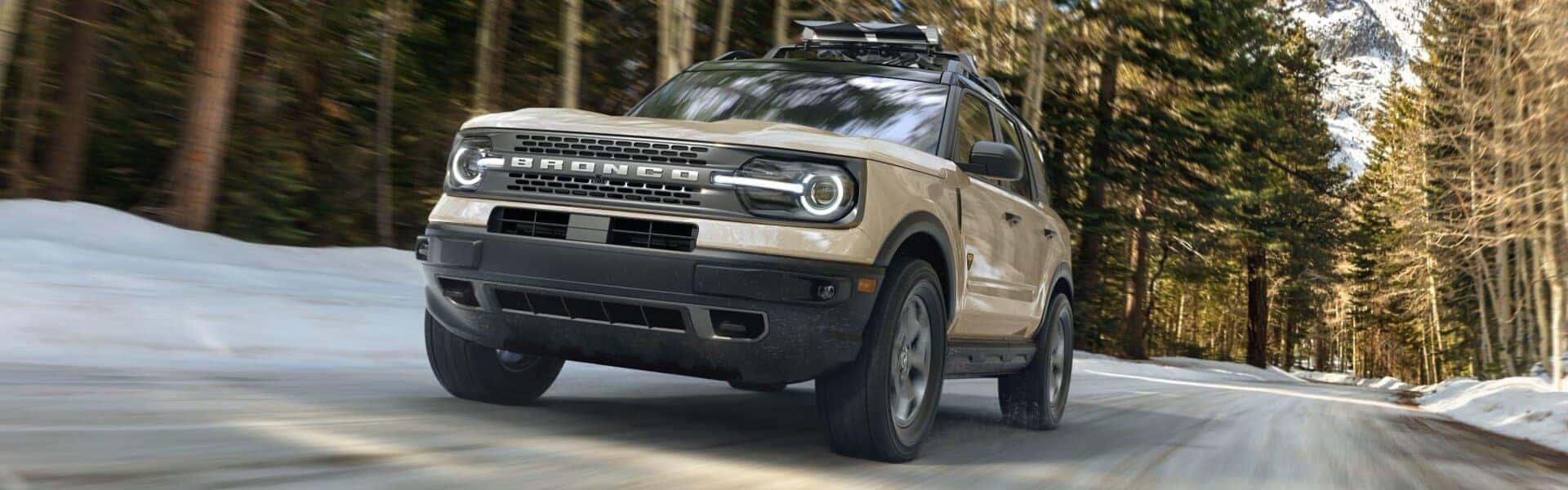 2024 Ford Bronco Sport Badlands Driving On The Street Past Trees