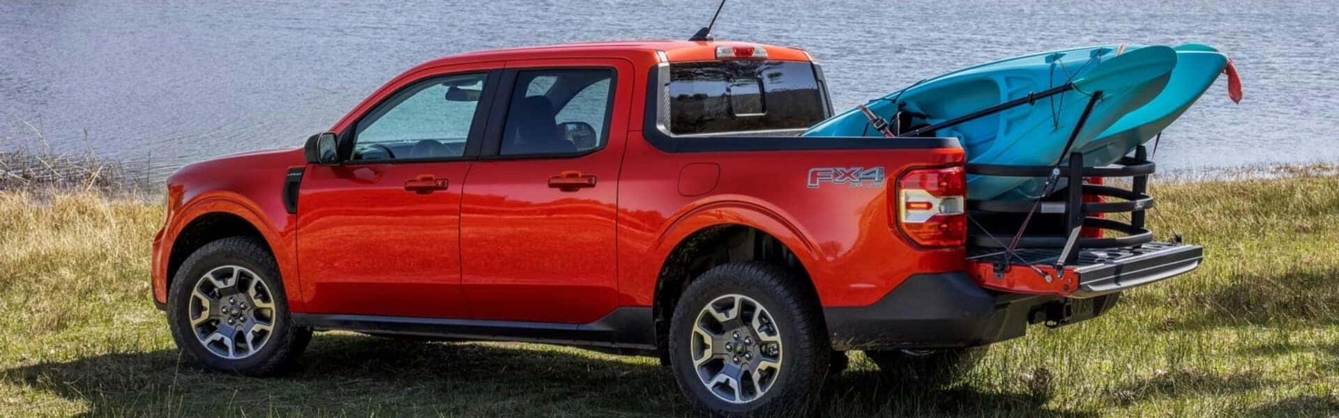 2024 Ford Maverick Parked on a Lakeshore With a Kayak Hanging out of the Truck Bed