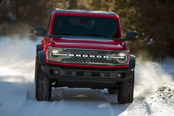 Red 2025 Ford Bronco off-roading in the snow