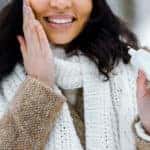 african american woman touching cheek and applying protective cream