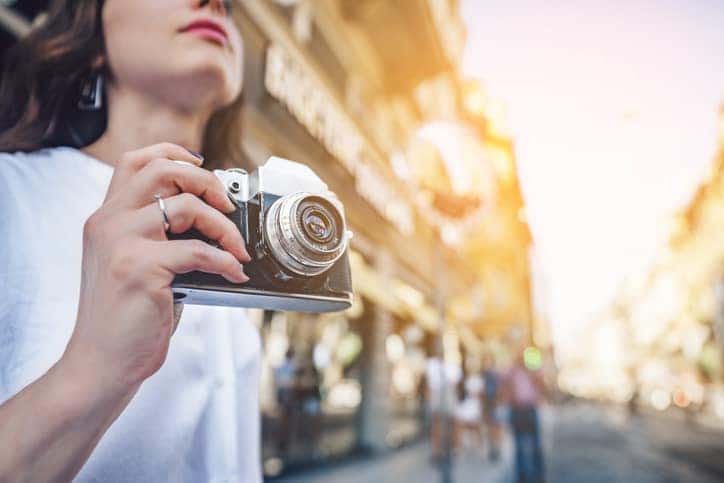 Young tourist with a retro camera