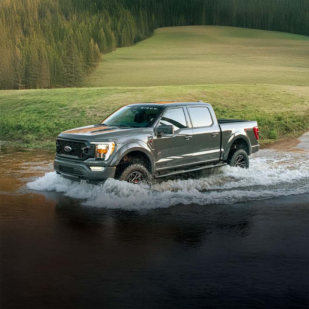 New F-150 Black Widow Custom Ford Truck Driving Through Water