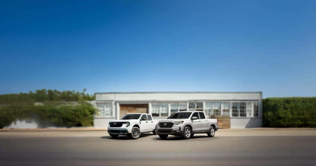 2025 Ford Maverick vs Honda Ridgeline parked outside of a hardware store