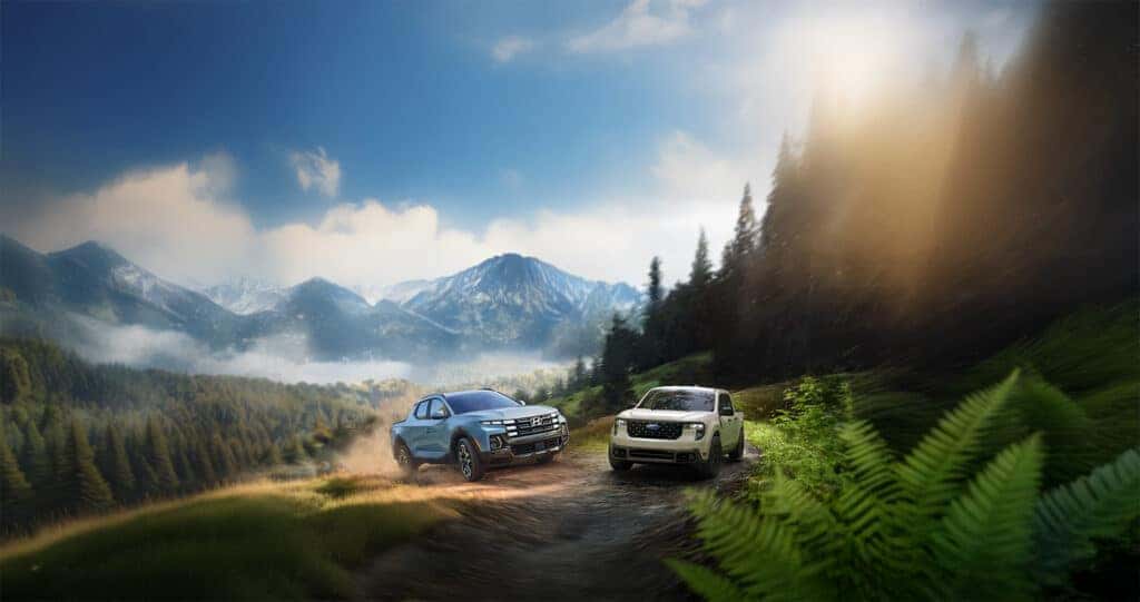 Ford Maverick vs Hyundai Santa Fe driving up a dirt road in the mountains