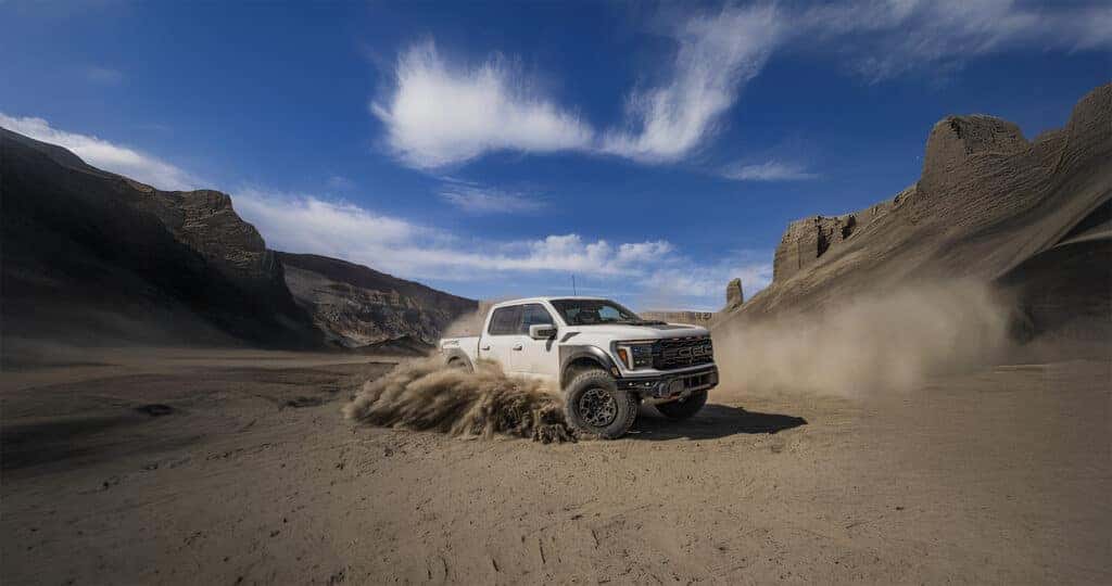Ford Raptor sliding through the dirt in a desert