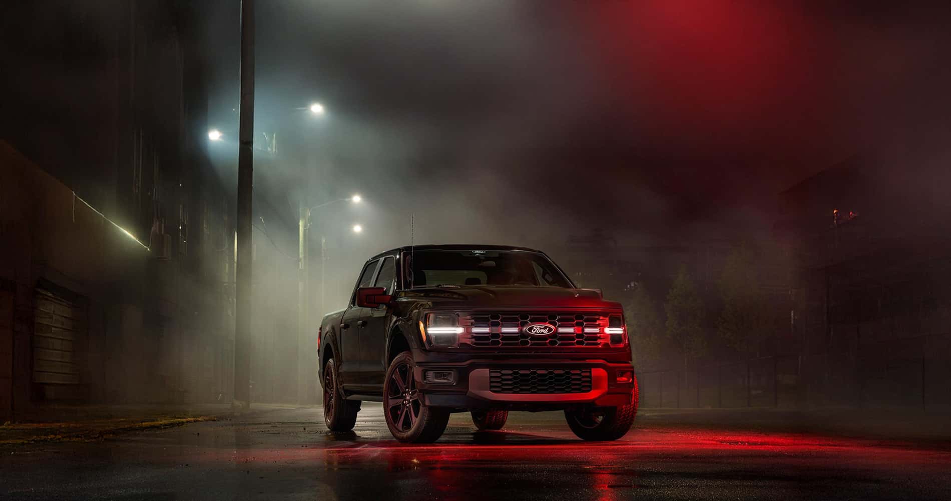 2026 Ford F-150 dimensions shown in a dim lit industrial road with red light overhead and fog