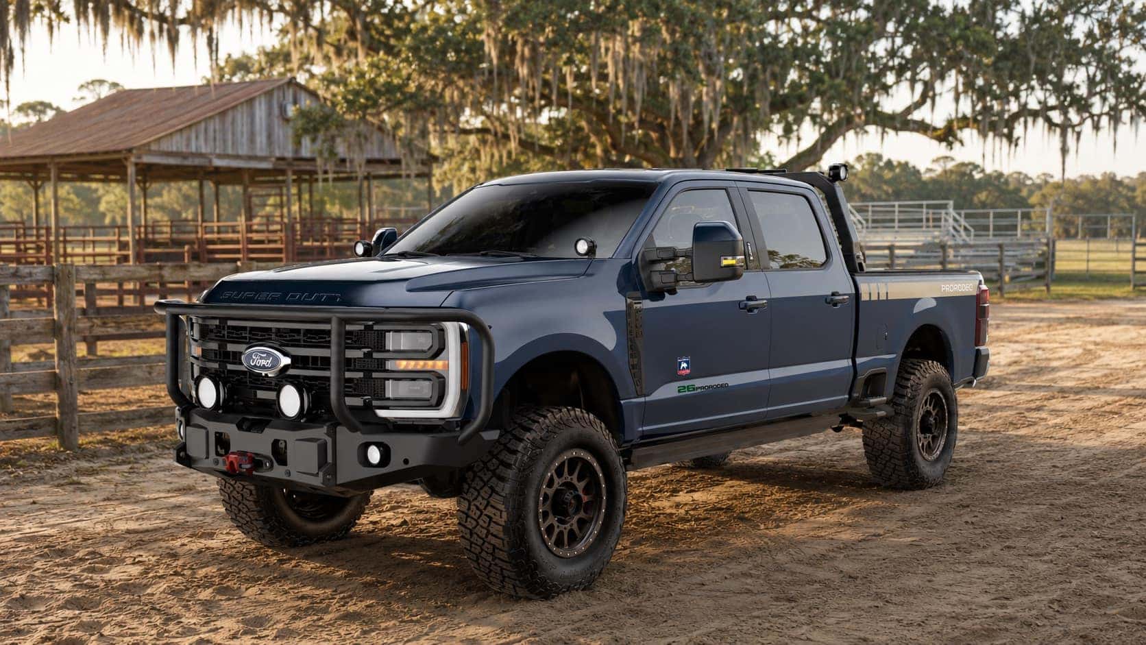 Dark gray 2026 Ford AGwagon PRORODEO Edition Super Duty parked beside an outdoor rodeo arena near Savannah, Georgia.