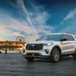 white 2025 Ford Explorer in front of fair and ferris wheel