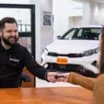 Sales Consultant with Client Handing Off Keys