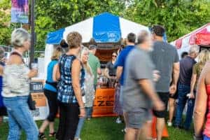 people walking past tent at Taste of Lakeville