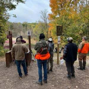 group of hunters gathering at station for clay shoot