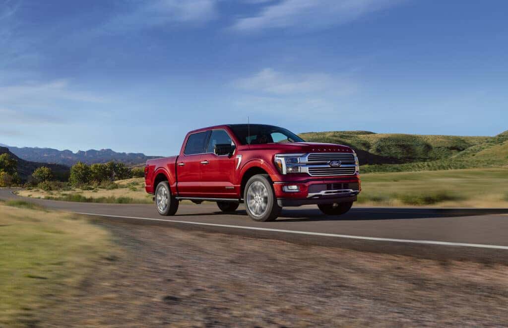 red 2025 Ford F-150 driving on road