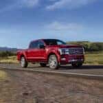 red 2025 Ford F-150 driving on road
