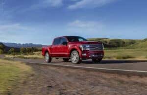 red 2025 Ford F-150 driving on road