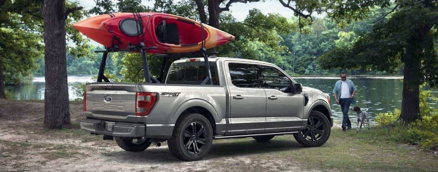 A grey 2023 Ford F-150 Sport near a lake.