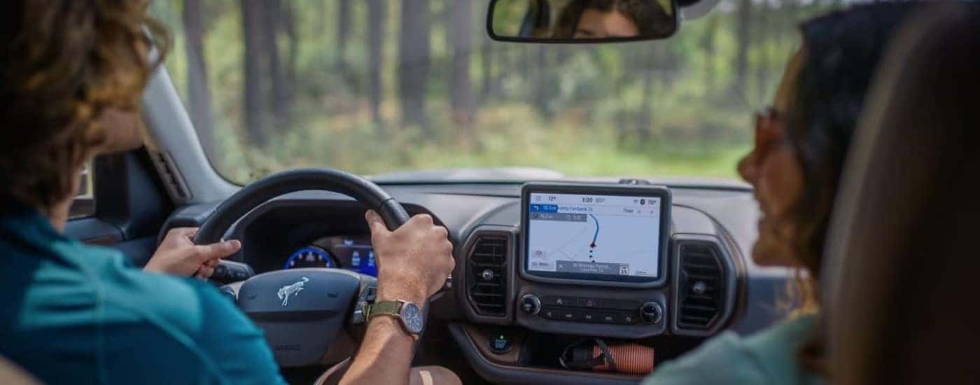 People are shown driving in a 2024 Ford Bronco Sport.