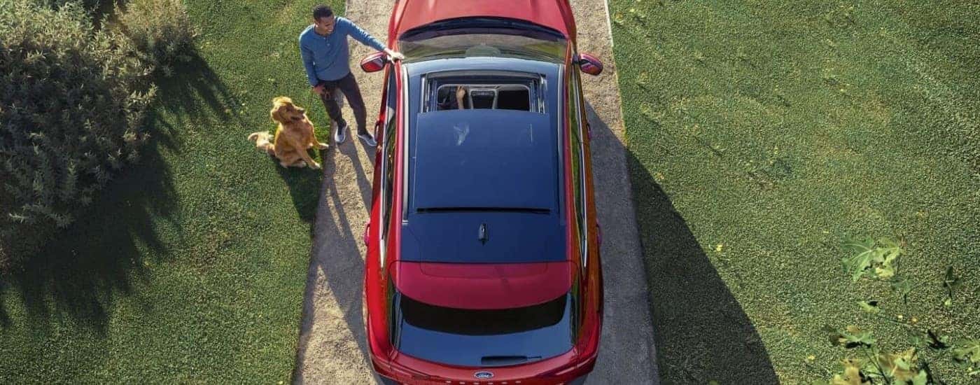 A red 2023 Ford Escape is shown parked in a driveway.