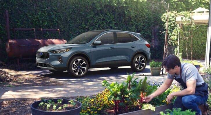 A grey 2024 Ford Escape Platinum is shown parked in a driveway after visiting a Marietta Ford dealer.