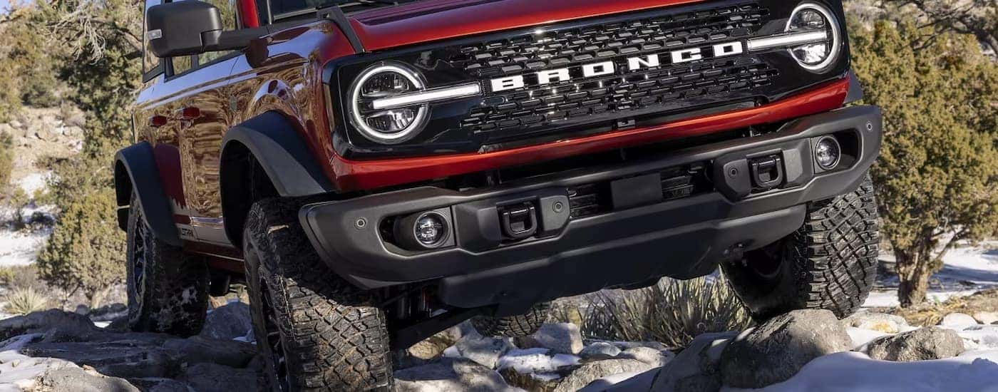 A close up of a red 2024 Ford Bronco Wildtrak off-roading is shown.