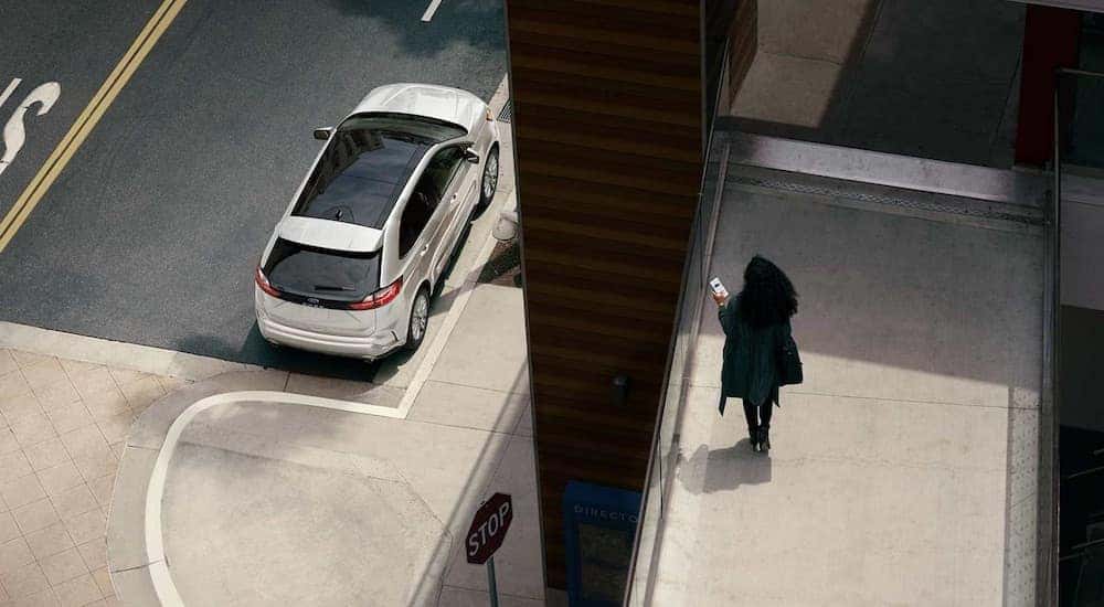 A white 2024 Ford Edge SE is shown from a high angle while parked near a curb.