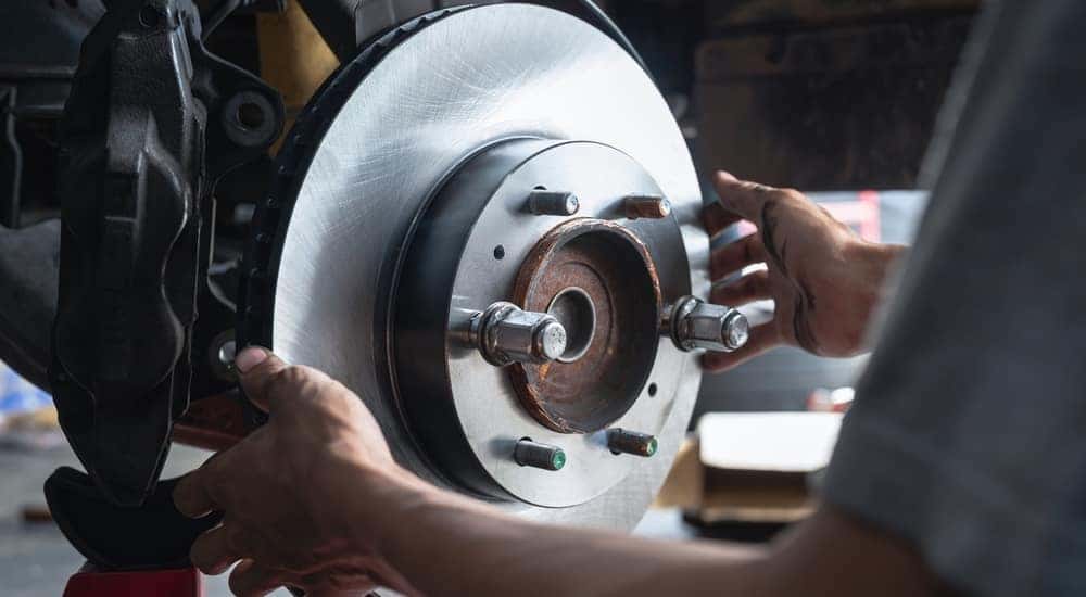 A mechanic is shown replacing brakes at a Ford service center near Smyrna.