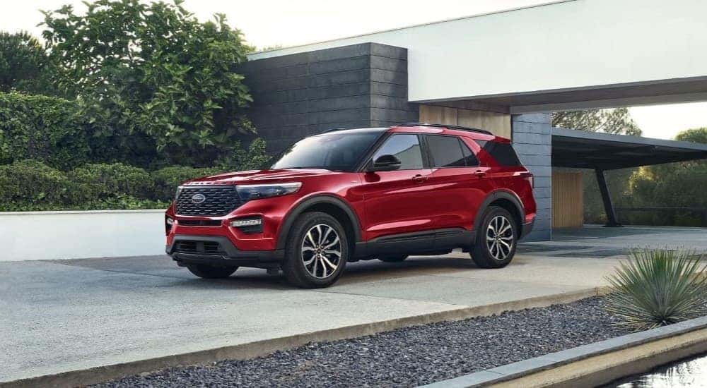 A red 2024 Ford Explorer ST-Line is shown parked on a driveway.