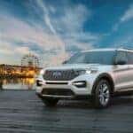 A white 2024 Ford Explorer is shown parked on a dock.