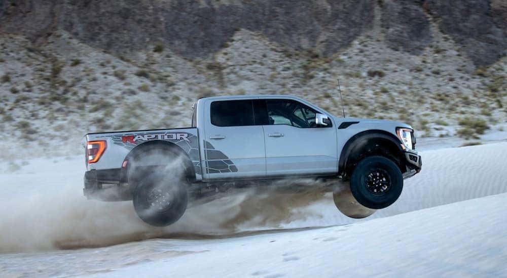 A silver 2025 Ford F-150 Raptor R is shown from the side.