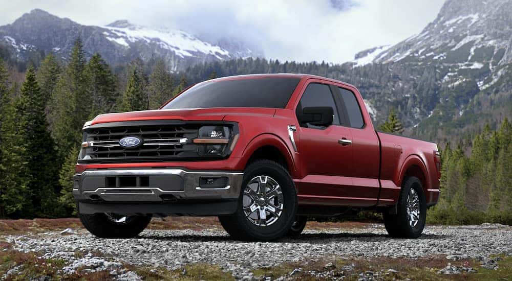 A red 2025 Ford F-150 XLT parked in the mountains.