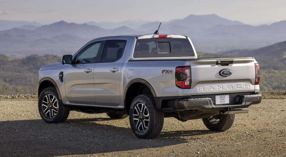 A silver 2025 Ford Ranger Lariat is shown from the rear at an angle.