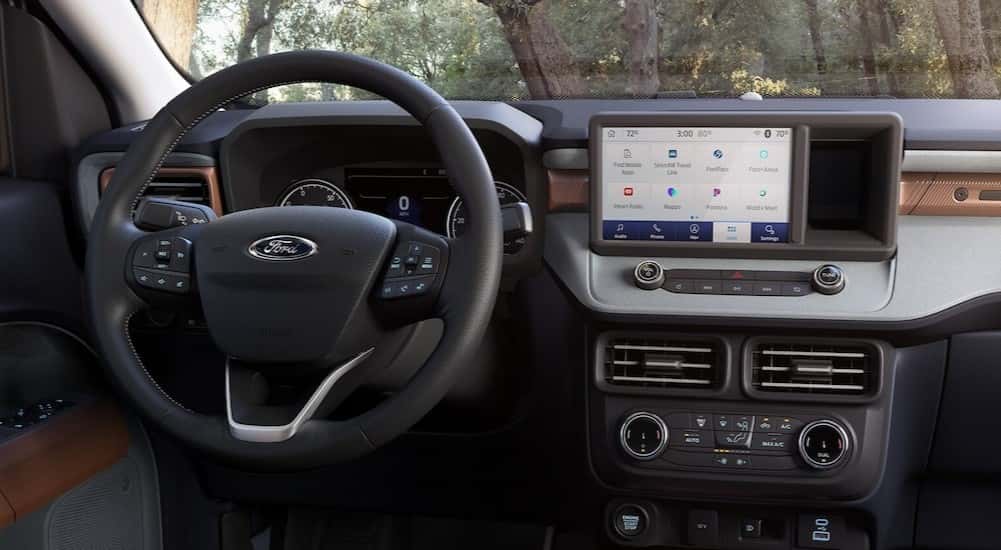 The black dashboard is shown in a 2025 Ford Maverick for sale.