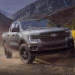 A grey 2025 Ford Ranger Lariat parked off-road on a mountain.