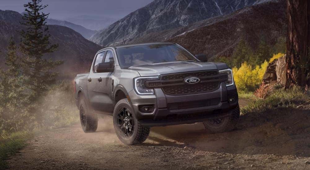 A grey 2025 Ford Ranger Lariat parked off-road on a mountain.