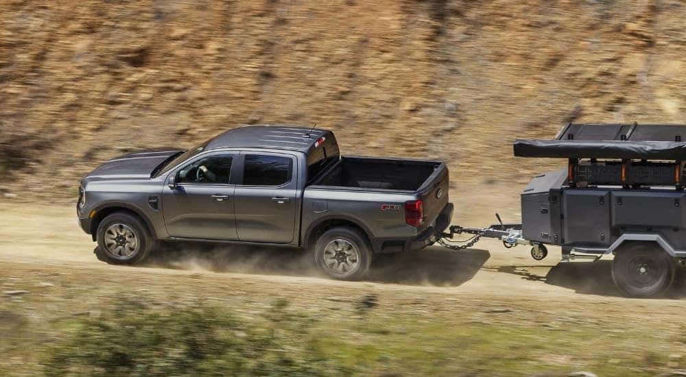 Overhead view of a grey 2025 Ford Ranger Lariat towing a trailer off-road.